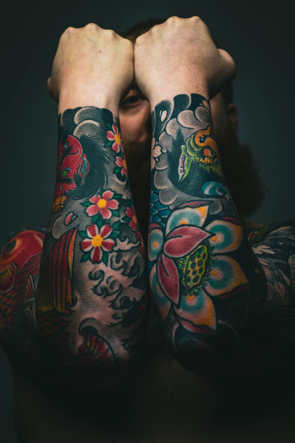 Bold, colorful Japanese-influenced tattoo sleeve with koi and floral motifs