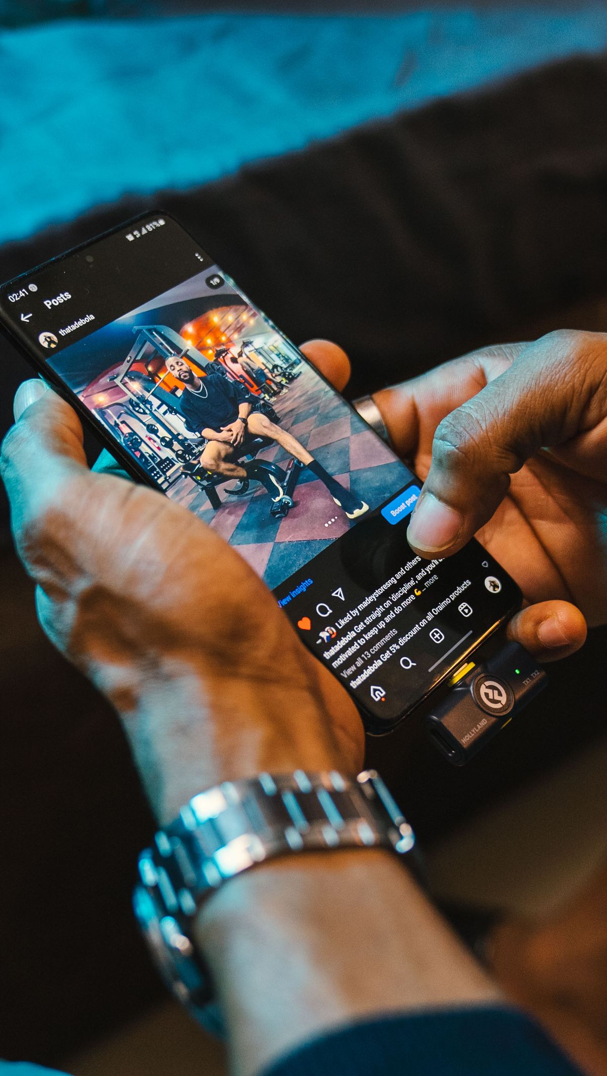 Hands browsing a social media feed on a smartphone