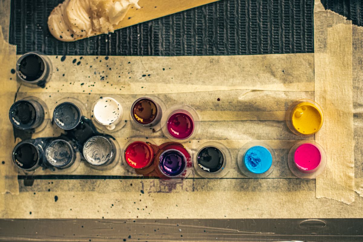 Colorful tattoo ink cups arranged on a studio workstation