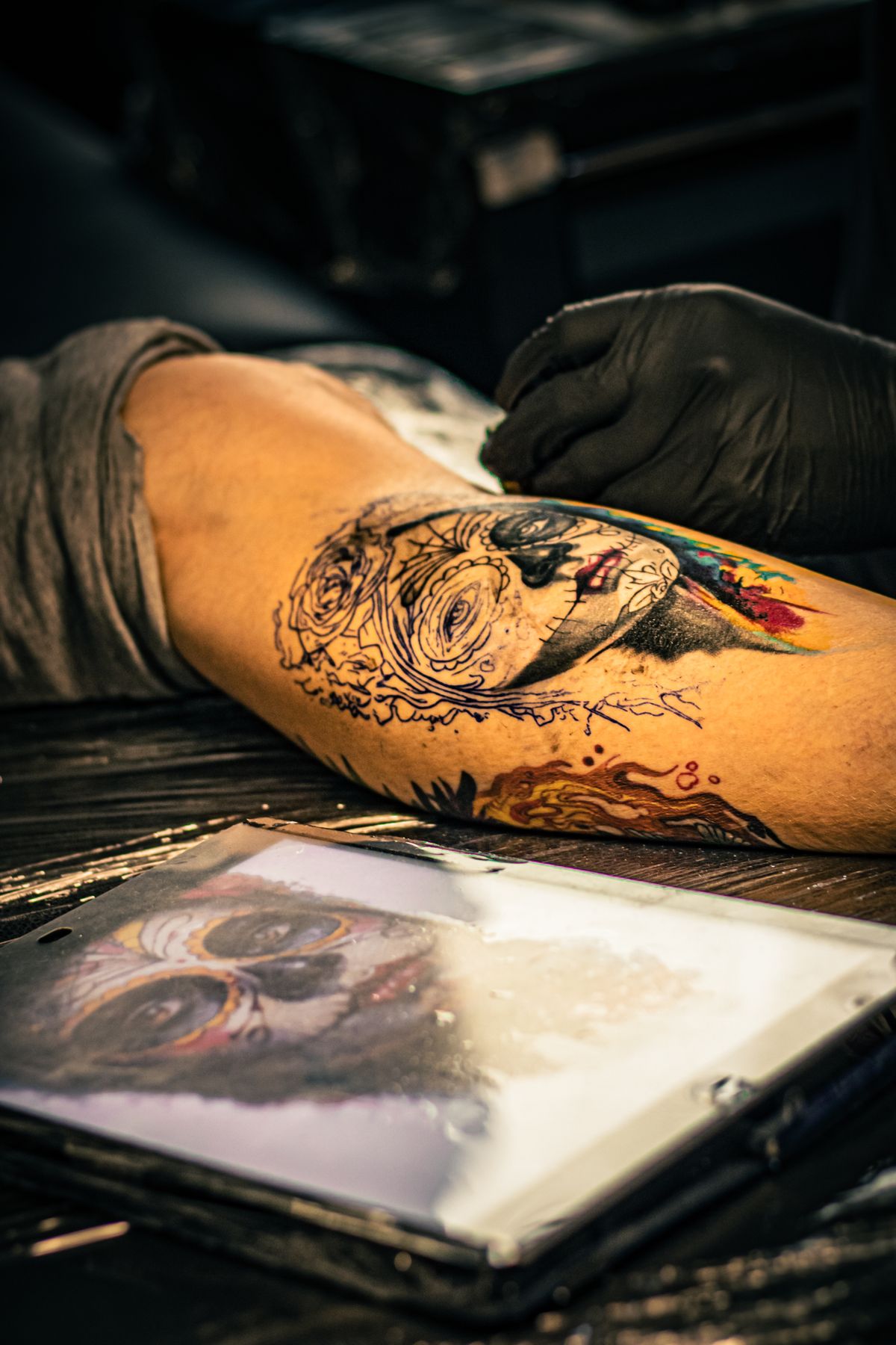 Vibrant colorful tattoo being inked in a studio