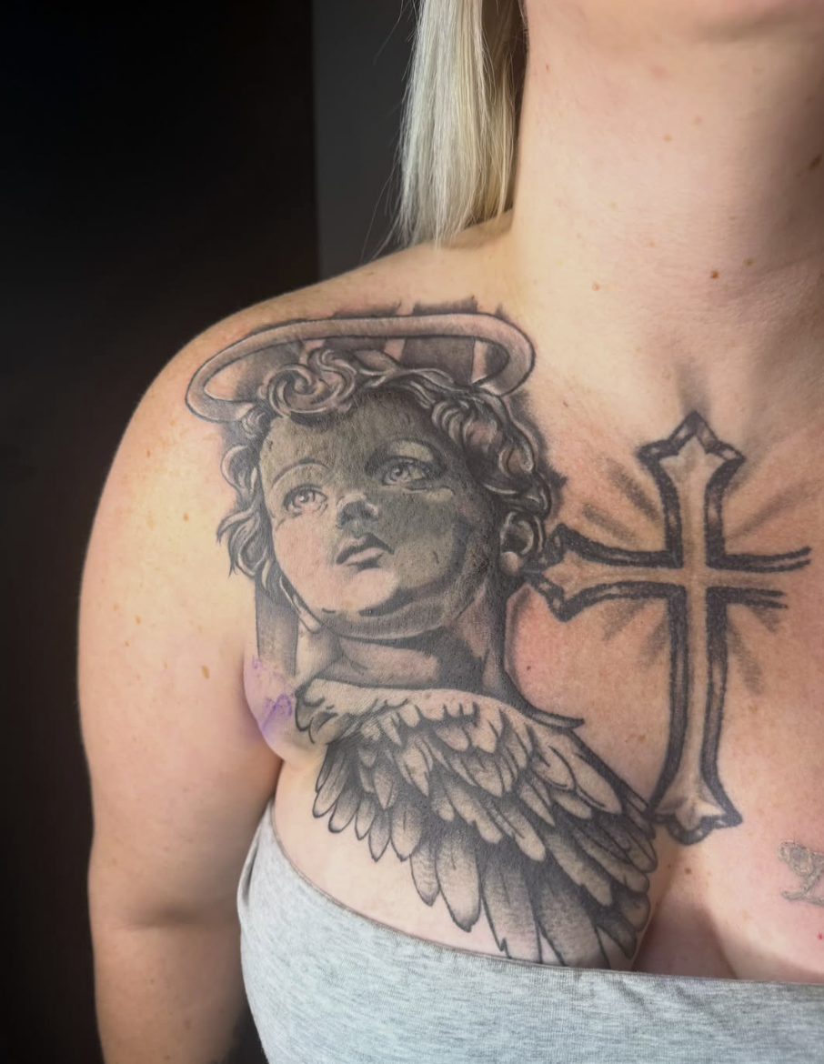 Black & grey cherub chest piece by Daniel Greene