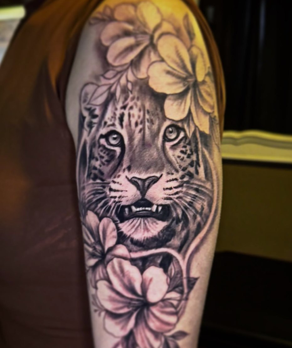 Black and grey leopard portrait with floral tattoo by David Mariscal