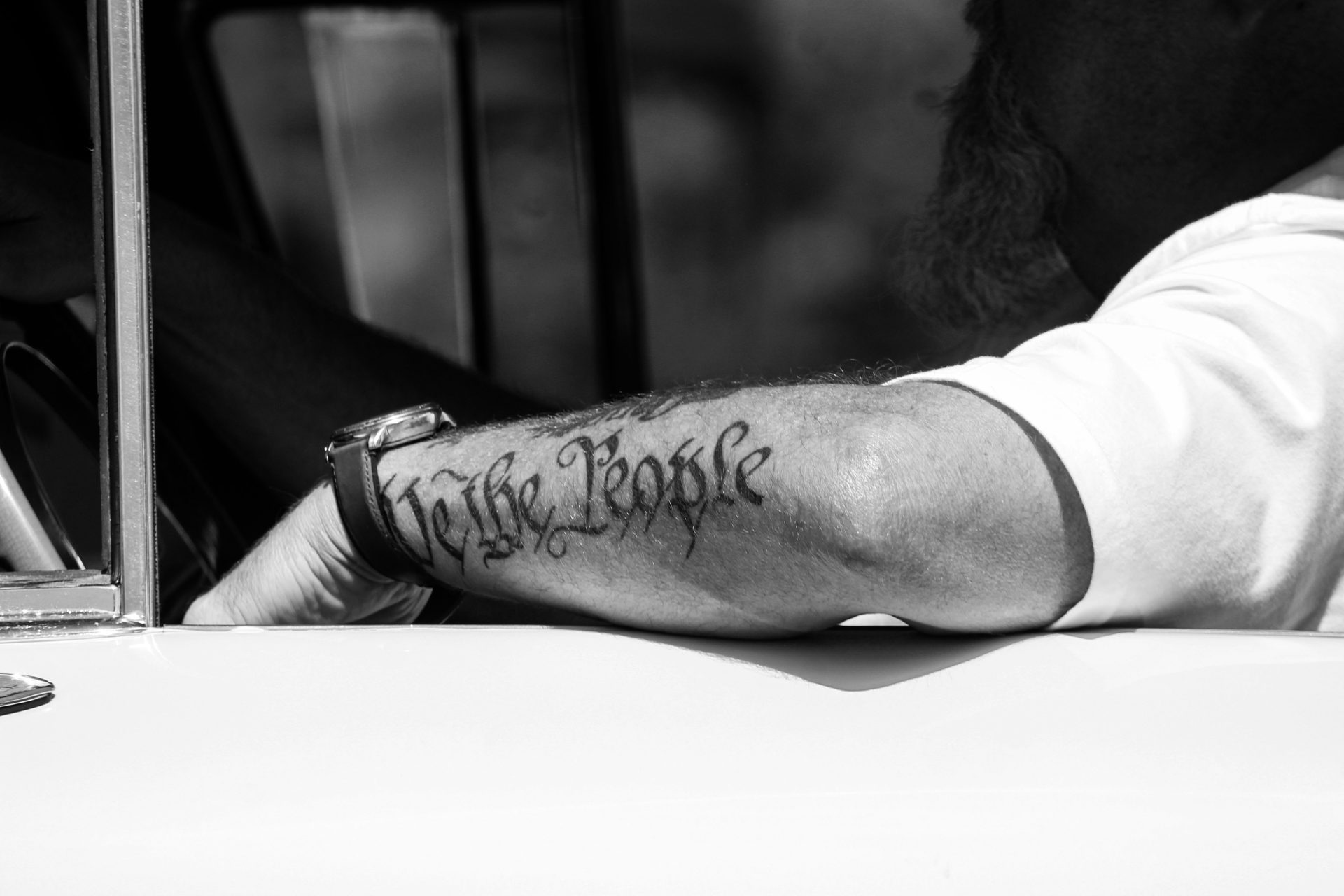 Close-up of a fine-line tattoo in progress under studio light