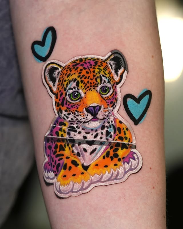 Colorful sticker-style leopard cub tattoo by Pony Lawson